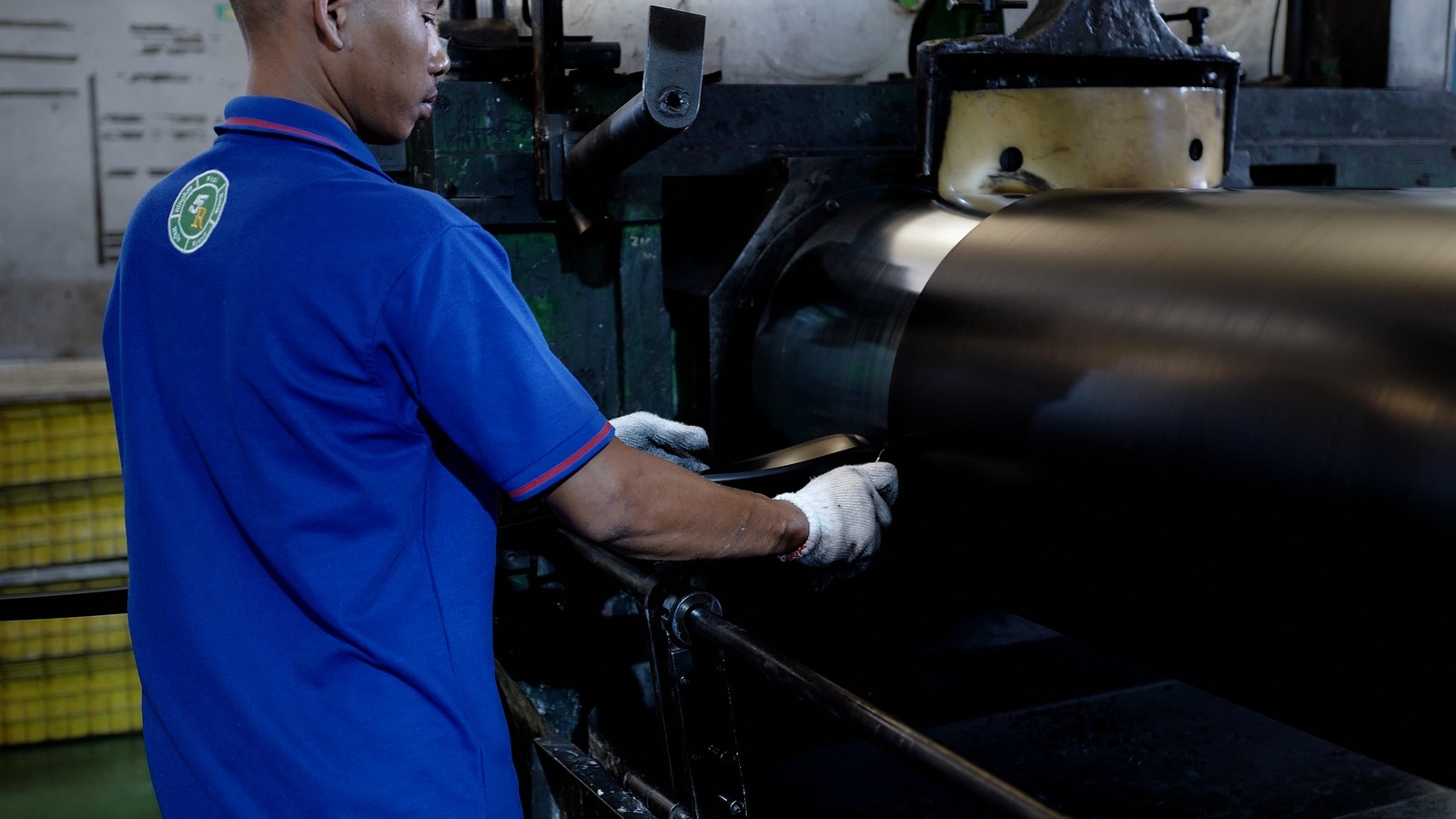Operator at the two-roll compounding mill where NBR, EPDM, and silicone rubber are mixed in-house