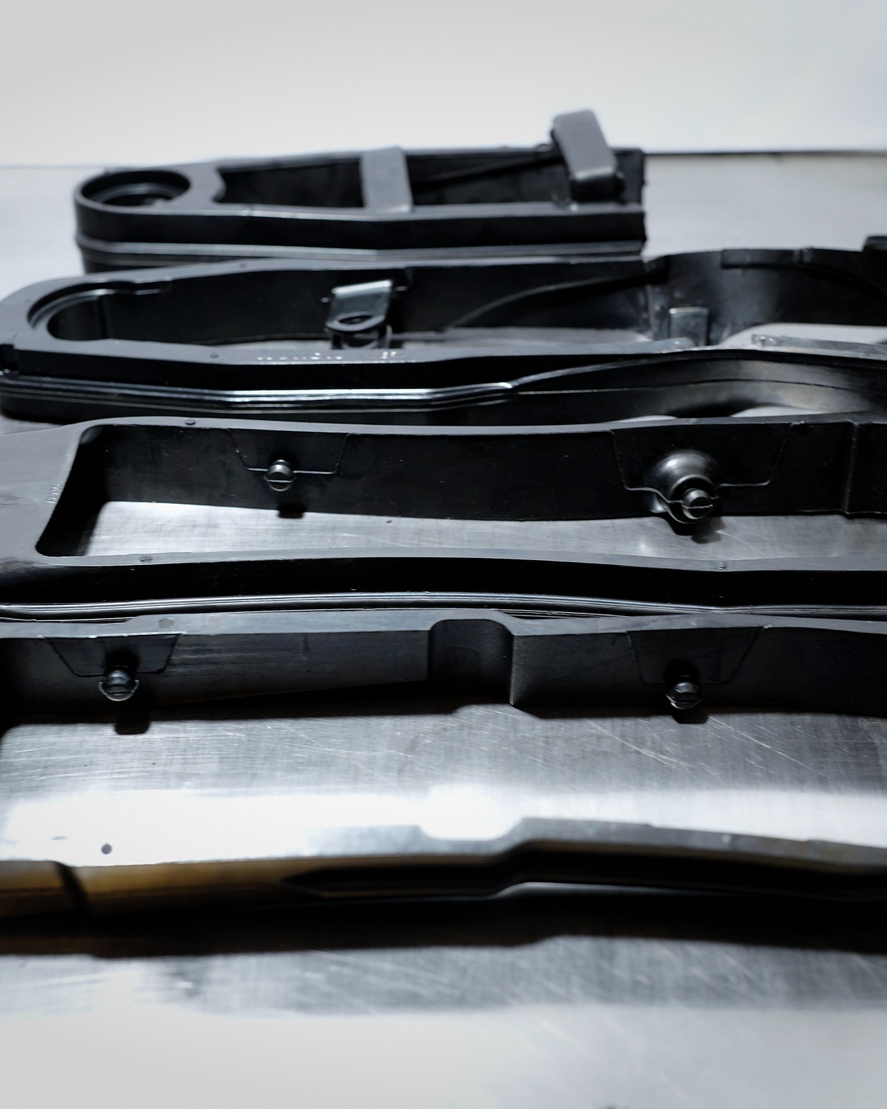 Two-wheel frame rail with bonded rubber boss — custom OEM sub-assembly