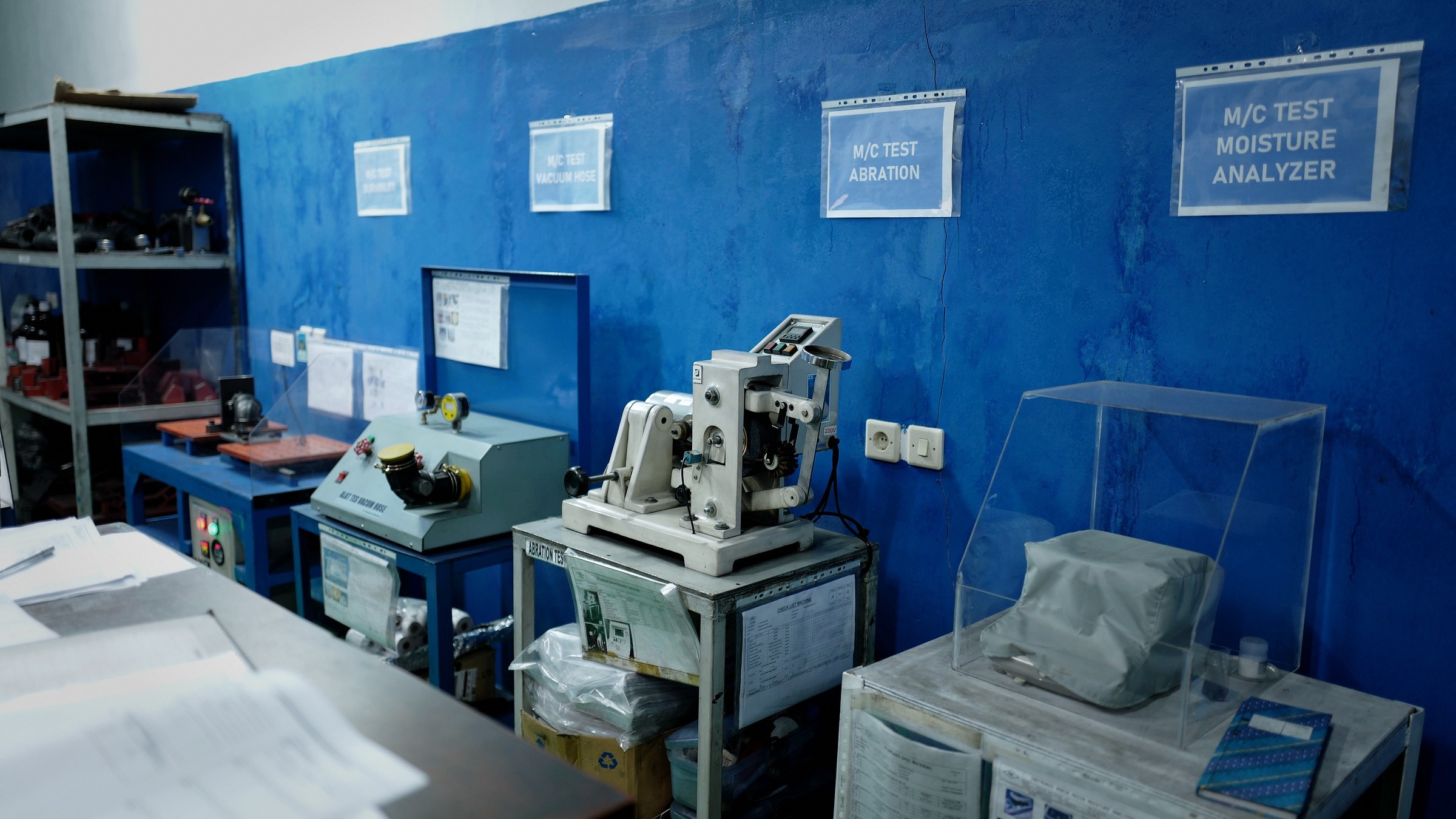 QC laboratory instrument wall — ozone, aging, and endurance testers in the SGS-certified lab